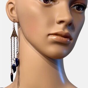Silver tone earrings with iridescent violet luster glass leaf beads on chain
